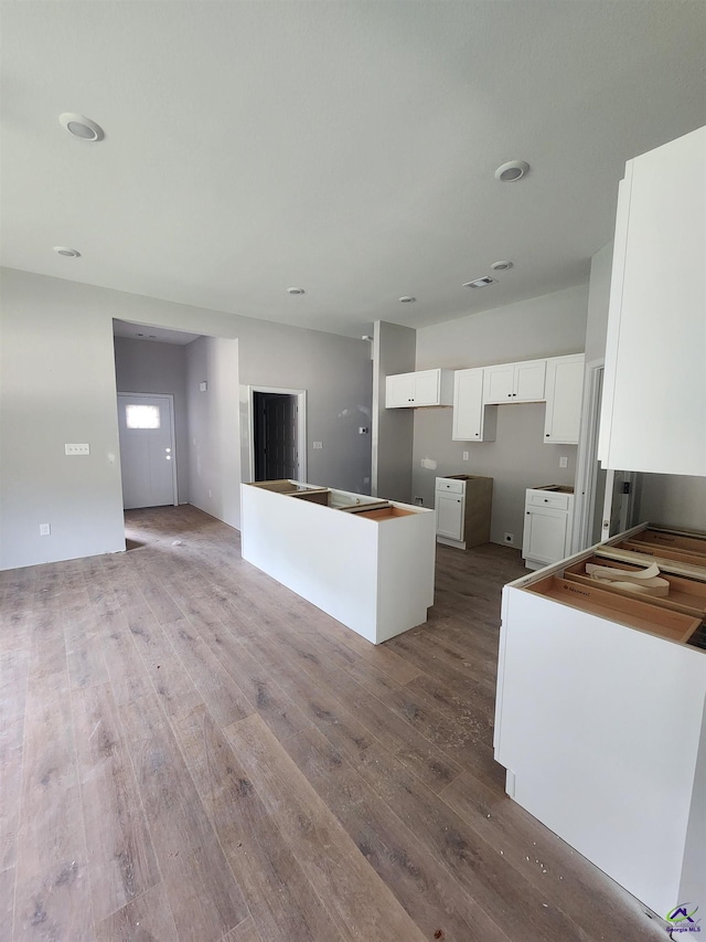 109 Silver Maple Ct, Byron, GA 31008 - kitchen featuring wood finished floors, white cabinetry, and a kitchen island