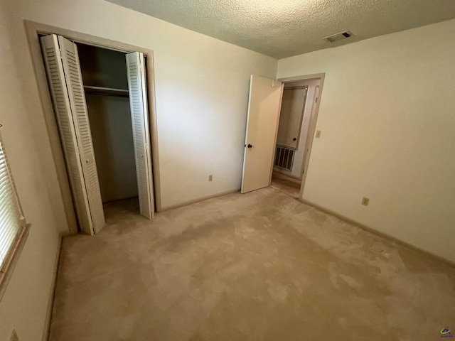 122 Cheryl Blvd, Warner Robins, GA 31088 - unfurnished bedroom with light carpet, a textured ceiling, and a closet
