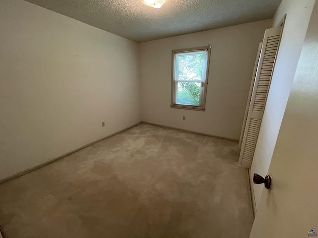122 Cheryl Blvd, Warner Robins, GA 31088 - unfurnished bedroom featuring light carpet, a textured ceiling, and a closet