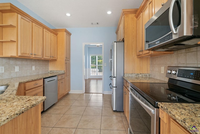107 Rachael Ln, Warner Robins, GA 31088 - kitchen with stainless steel appliances, light stone countertops, backsplash, open shelves, and light tile patterned floors