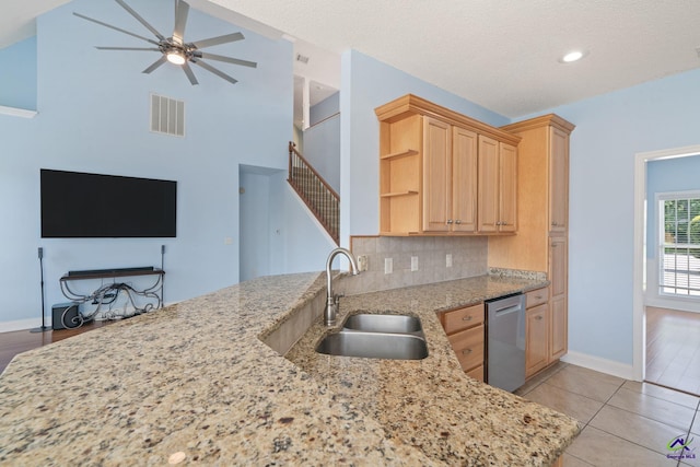 107 Rachael Ln, Warner Robins, GA 31088 - kitchen with stainless steel dishwasher, light brown cabinets, ceiling fan, light stone counters, and recessed lighting