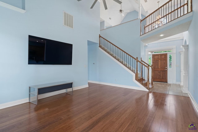 107 Rachael Ln, Warner Robins, GA 31088 - unfurnished living room with wood finished floors, stairs, ceiling fan, and high vaulted ceiling