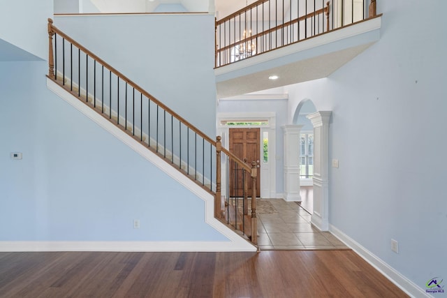 107 Rachael Ln, Warner Robins, GA 31088 - foyer entrance with ornate columns, arched walkways, wood finished floors, stairway, and a high ceiling