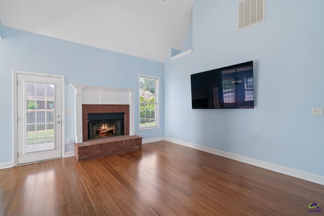 107 Rachael Ln, Warner Robins, GA 31088 - unfurnished living room featuring wood finished floors, a fireplace, and high vaulted ceiling