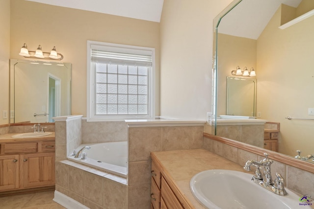 107 Rachael Ln, Warner Robins, GA 31088 - full bathroom with two vanities, a bath, lofted ceiling, and tile patterned flooring