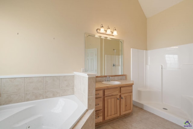 107 Rachael Ln, Warner Robins, GA 31088 - full bath with a tub with jets, vaulted ceiling, vanity, tile patterned floors, and walk in shower