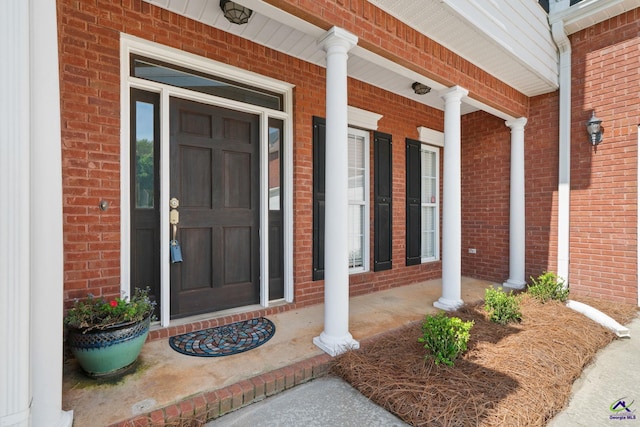 107 Rachael Ln, Warner Robins, GA 31088 - doorway to property featuring covered porch and brick siding