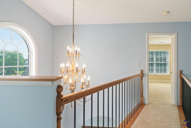 107 Rachael Ln, Warner Robins, GA 31088 - hall with a chandelier, an upstairs landing, carpet floors, and plenty of natural light