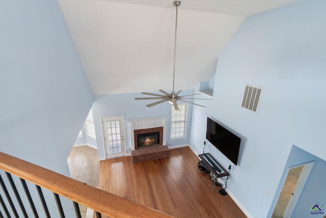 107 Rachael Ln, Warner Robins, GA 31088 - unfurnished living room with ceiling fan, a fireplace, high vaulted ceiling, and wood finished floors