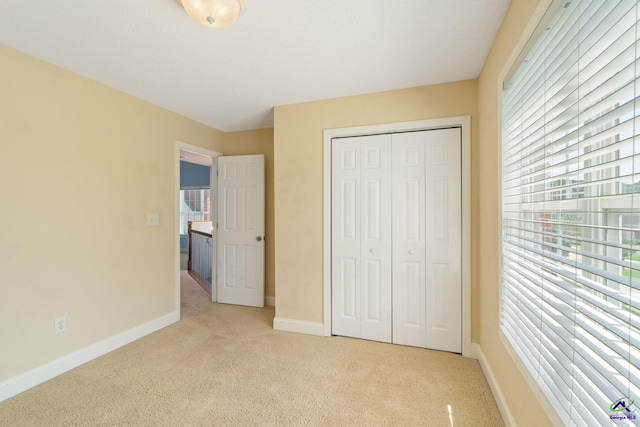 107 Rachael Ln, Warner Robins, GA 31088 - unfurnished bedroom featuring light colored carpet, multiple windows, and a closet
