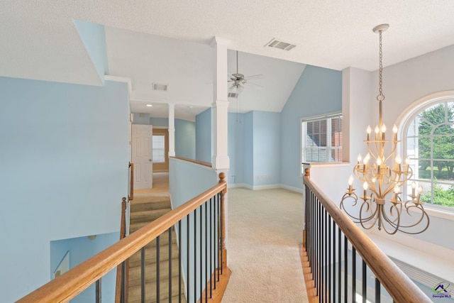 107 Rachael Ln, Warner Robins, GA 31088 - hall with a chandelier, carpet floors, an upstairs landing, lofted ceiling, and a textured ceiling
