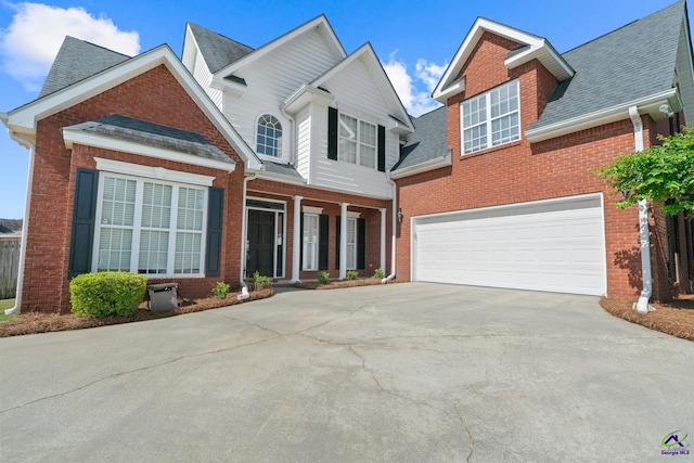 107 Rachael Ln, Warner Robins, GA 31088 - traditional-style house with concrete driveway, brick siding, an attached garage, a shingled roof, and covered porch
