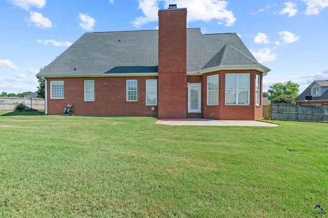 107 Rachael Ln, Warner Robins, GA 31088 - back of property with a patio, a shingled roof, brick siding, and a chimney