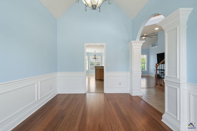 107 Rachael Ln, Warner Robins, GA 31088 - empty room featuring vaulted ceiling, plenty of natural light, a chandelier, a wainscoted wall, and stairway