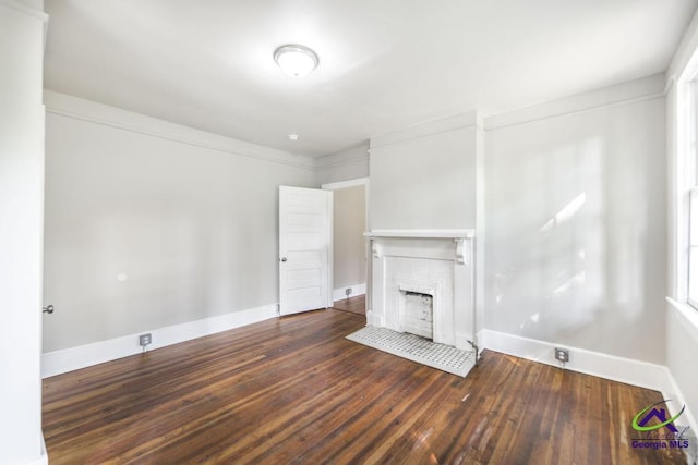 138 Comer Ter, Macon, GA 31204 - unfurnished living room with baseboards, a tile fireplace, and hardwood / wood-style flooring