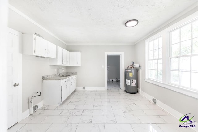 138 Comer Ter, Macon, GA 31204 - laundry area with water heater, light marble finish floors, baseboards, a textured ceiling, and cabinet space