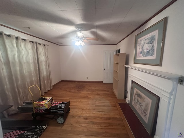 715 Miller Dr, Warner Robins, GA 31093 - unfurnished living room featuring hardwood / wood-style flooring, a ceiling fan, crown molding, and a fireplace