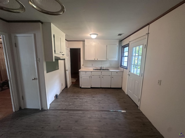715 Miller Dr, Warner Robins, GA 31093 - kitchen featuring a sink, white cabinets, dark wood-style floors, light countertops, and under cabinet range hood