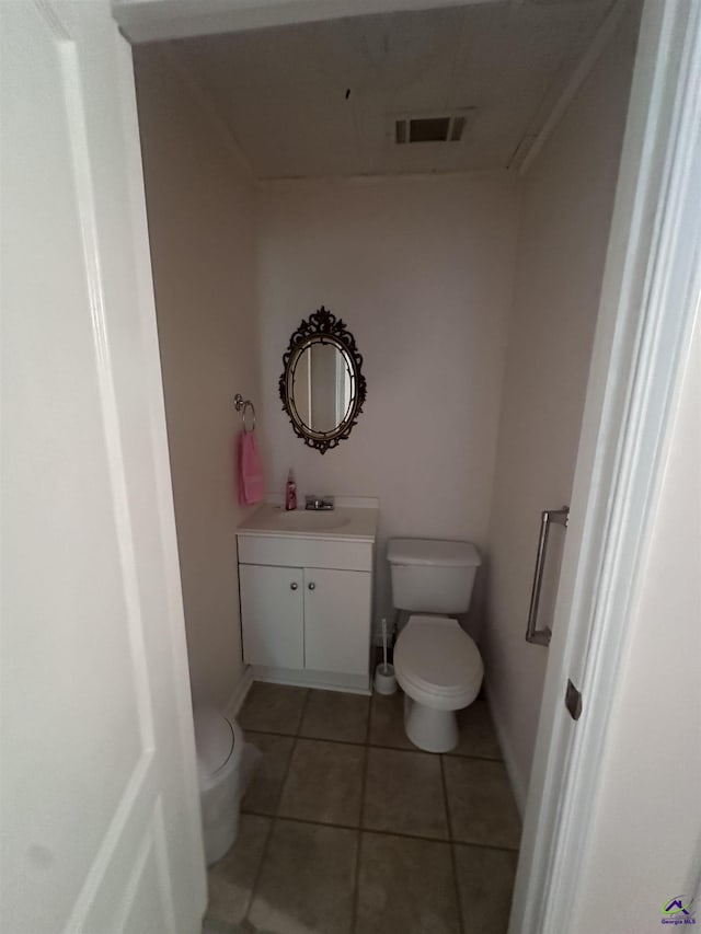 715 Miller Dr, Warner Robins, GA 31093 - bathroom featuring toilet, vanity, tile patterned floors, and baseboards