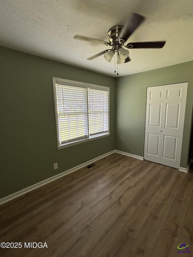 867 S Forest Lake Dr, Macon, GA 31201 - unfurnished bedroom featuring dark wood-style floors, a textured ceiling, baseboards, and a ceiling fan
