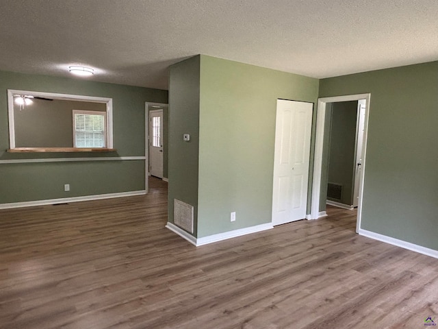 867 S Forest Lake Dr, Macon, GA 31201 - unfurnished room featuring wood finished floors, a textured ceiling, and baseboards