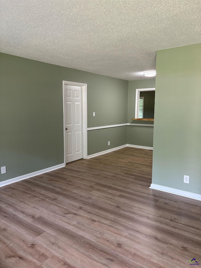 867 S Forest Lake Dr, Macon, GA 31201 - spare room with a textured ceiling, wood finished floors, and baseboards
