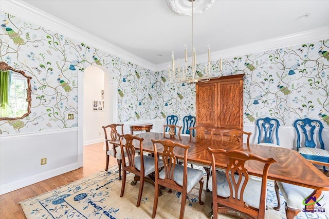 116 Maimont Cir, Macon, GA 31210 - dining area with crown molding, wallpapered walls, arched walkways, light wood-style flooring, and baseboards