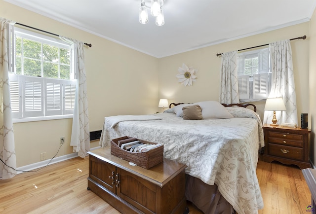 518 College St, Montezuma, GA 31063 - bedroom featuring multiple windows, light wood finished floors, crown molding, and baseboards