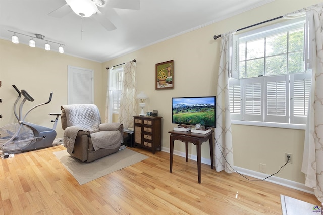 518 College St, Montezuma, GA 31063 - sitting room featuring crown molding, wood finished floors, healthy amount of natural light, and a ceiling fan