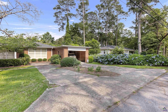 518 College St, Montezuma, GA 31063 - view of front of house with brick siding, concrete driveway, a front yard, and a carport