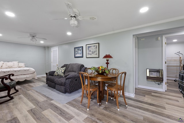 518 College St, Montezuma, GA 31063 - living area featuring heating unit, wood finished floors, ceiling fan, crown molding, and baseboards