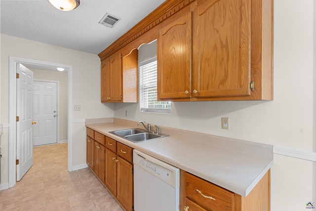 315 Woods Trl, Perry, GA 31069 - kitchen featuring dishwasher, a sink, light countertops, baseboards, and brown cabinetry