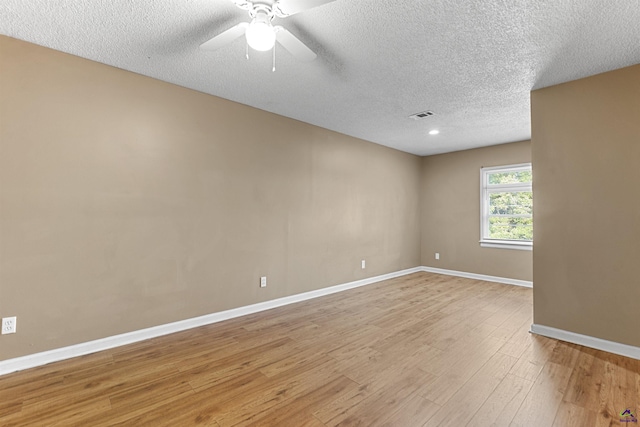 2105 Mutual Ave, Macon, GA 31204 - spare room featuring baseboards, a textured ceiling, light wood-type flooring, and ceiling fan