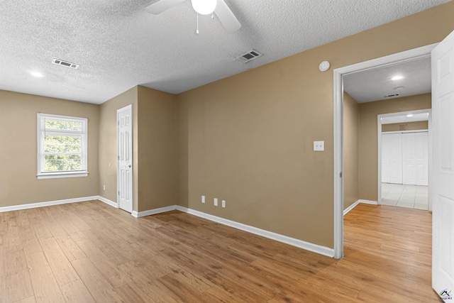 2105 Mutual Ave, Macon, GA 31204 - unfurnished room featuring light wood-style floors, baseboards, a textured ceiling, ceiling fan, and a smoke detector