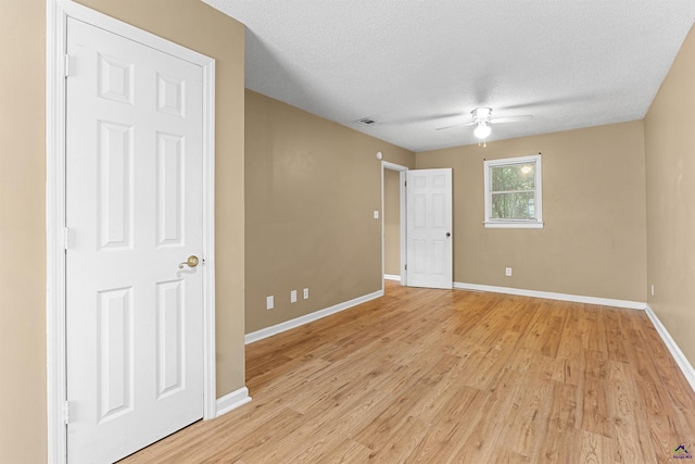 2105 Mutual Ave, Macon, GA 31204 - unfurnished room with a ceiling fan, baseboards, light wood-type flooring, and a textured ceiling