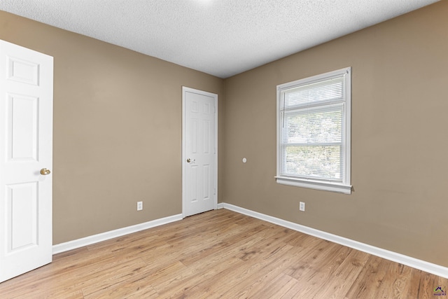 2105 Mutual Ave, Macon, GA 31204 - spare room with light wood-style floors, baseboards, and a textured ceiling