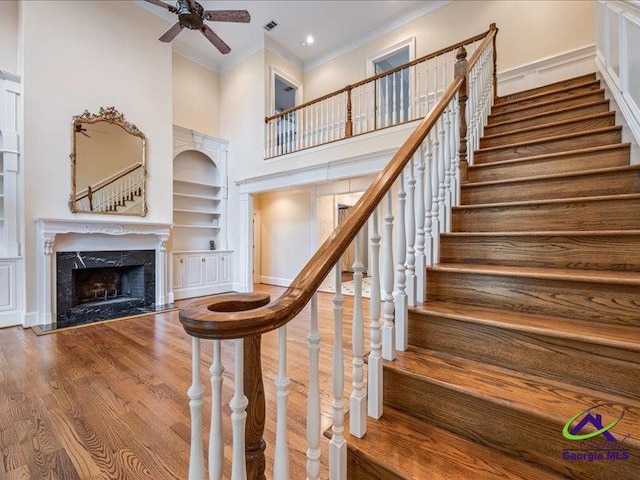 113 Troon Way, Macon, GA 31210 - stairs with crown molding, ceiling fan, built in shelves, a high end fireplace, and wood finished floors