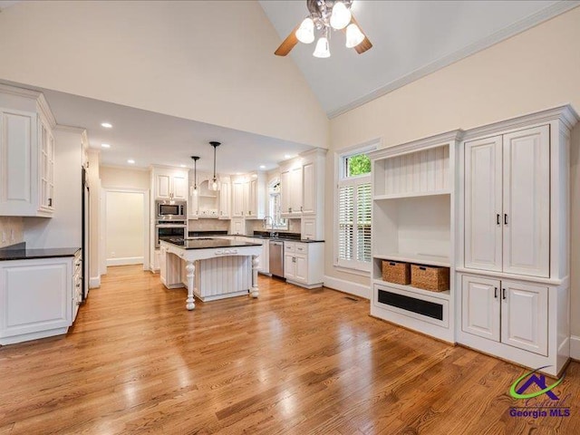 113 Troon Way, Macon, GA 31210 - kitchen with stainless steel appliances, open shelves, dark countertops, a ceiling fan, and a kitchen island