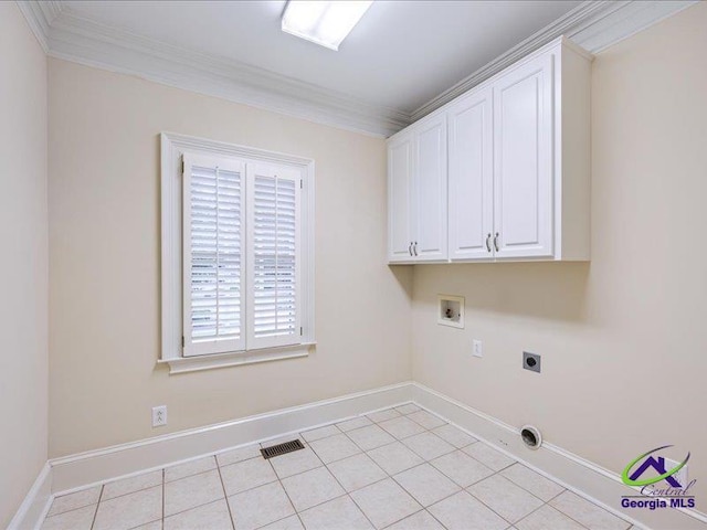 113 Troon Way, Macon, GA 31210 - laundry area with ornamental molding, hookup for an electric dryer, cabinet space, hookup for a washing machine, and light tile patterned floors