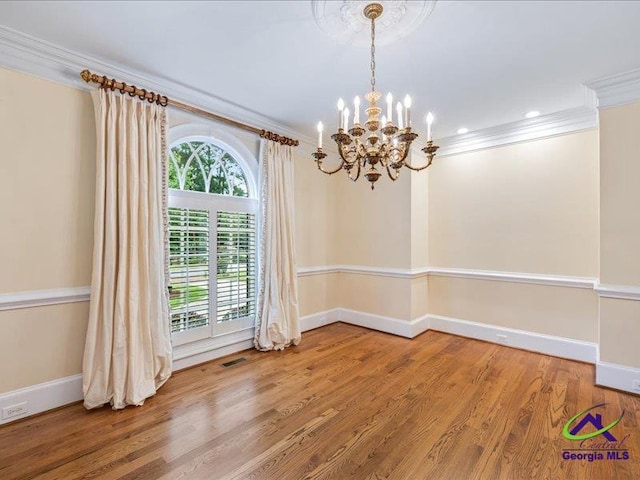 113 Troon Way, Macon, GA 31210 - spare room featuring ornamental molding, a chandelier, plenty of natural light, baseboards, and wood finished floors