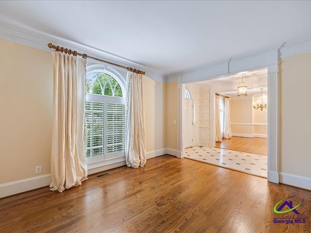 113 Troon Way, Macon, GA 31210 - empty room with ornamental molding, a chandelier, wood finished floors, and baseboards