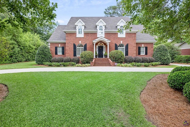 113 Troon Way, Macon, GA 31210 - colonial house featuring brick siding, a front yard, and roof with shingles