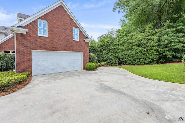 113 Troon Way, Macon, GA 31210 - view of side of home featuring a garage, brick siding, driveway, and a lawn