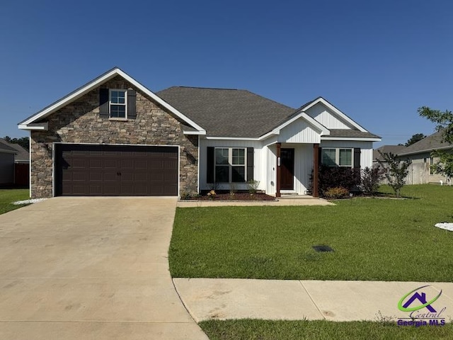 107 Huxley Ter, Bonaire, GA 31005 - view of front of house with driveway, a front yard, board and batten siding, and roof with shingles