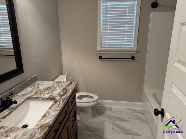107 Huxley Ter, Bonaire, GA 31005 - bathroom with marble look tile flooring, vanity, toilet, and baseboards