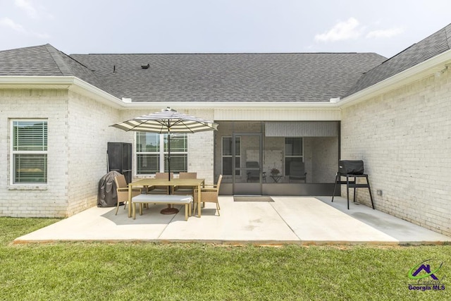 107 Field View Ln, Kathleen, GA 31047 - rear view of house with a shingled roof, brick siding, a patio area, a sunroom, and a lawn