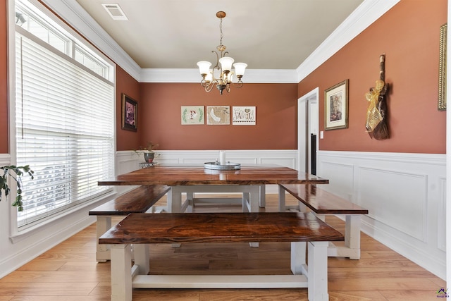 2725 Moseley Rd, Byron, GA 31008 - dining room with a chandelier, a wainscoted wall, light wood-style floors, and crown molding