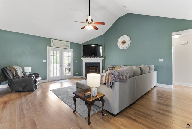 2725 Moseley Rd, Byron, GA 31008 - living area with a ceiling fan, high vaulted ceiling, wood finished floors, a fireplace, and baseboards