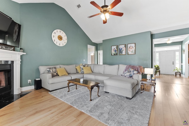 2725 Moseley Rd, Byron, GA 31008 - living area with high vaulted ceiling, a ceiling fan, wood finished floors, a fireplace, and baseboards
