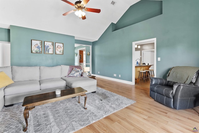 2725 Moseley Rd, Byron, GA 31008 - living area featuring ceiling fan, wood finished floors, high vaulted ceiling, and baseboards